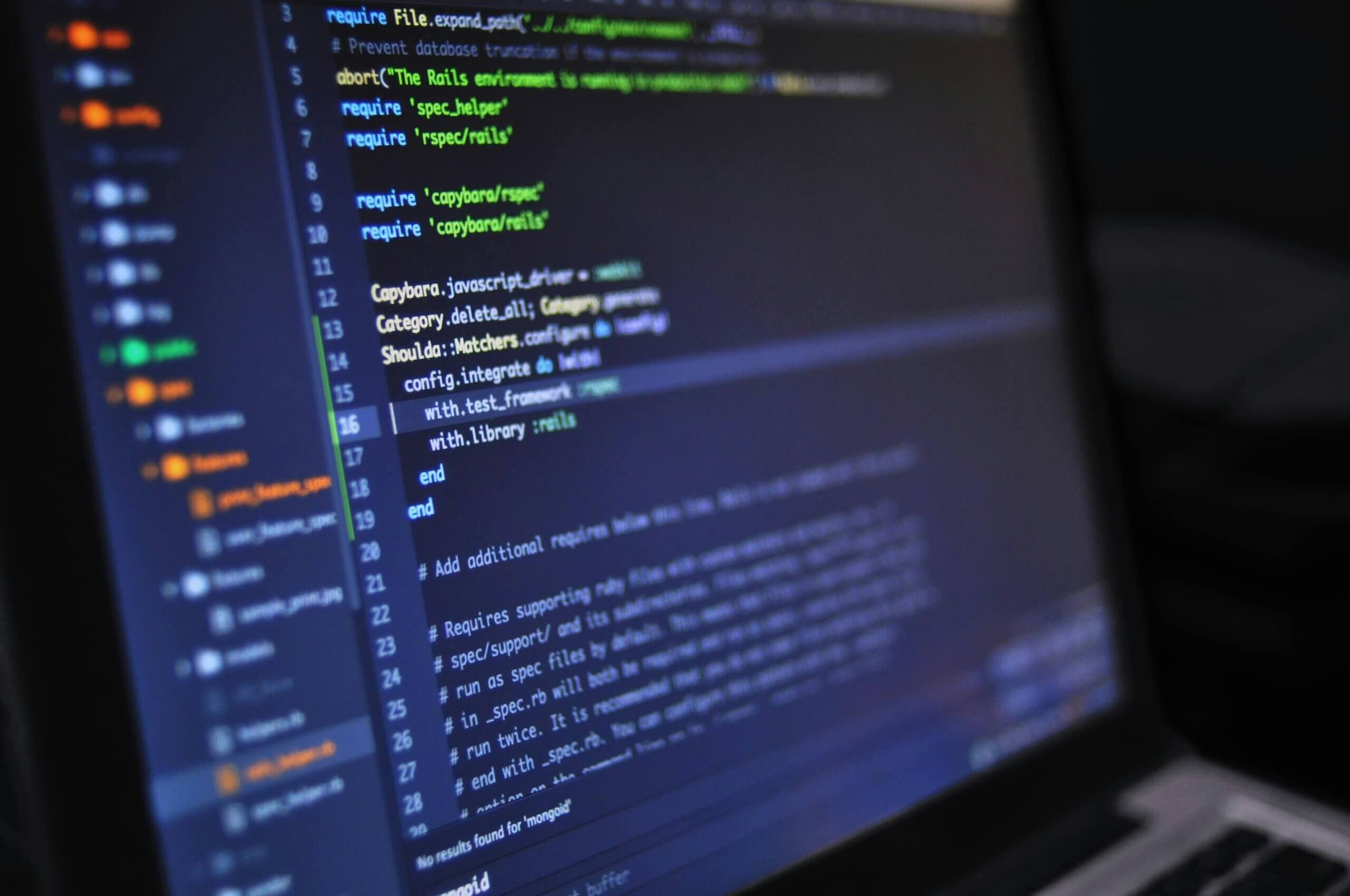 code filling a laptop screen in a dark editor, the output a security pass has to verify